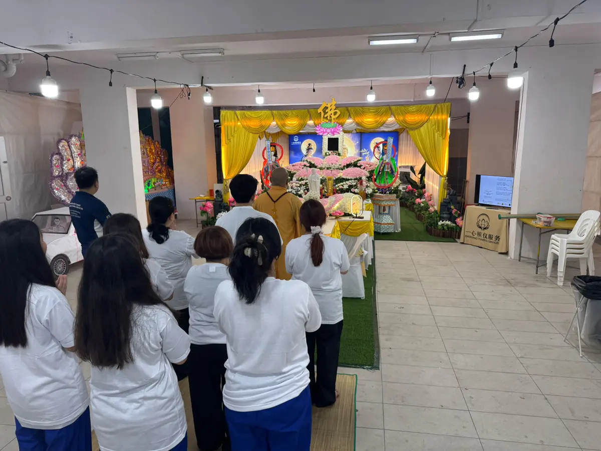 Family attending a Buddhist funeral prayer service