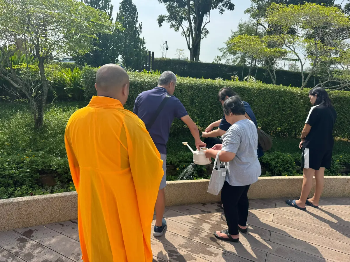 Family performing Buddhist ash scattering with a monk
