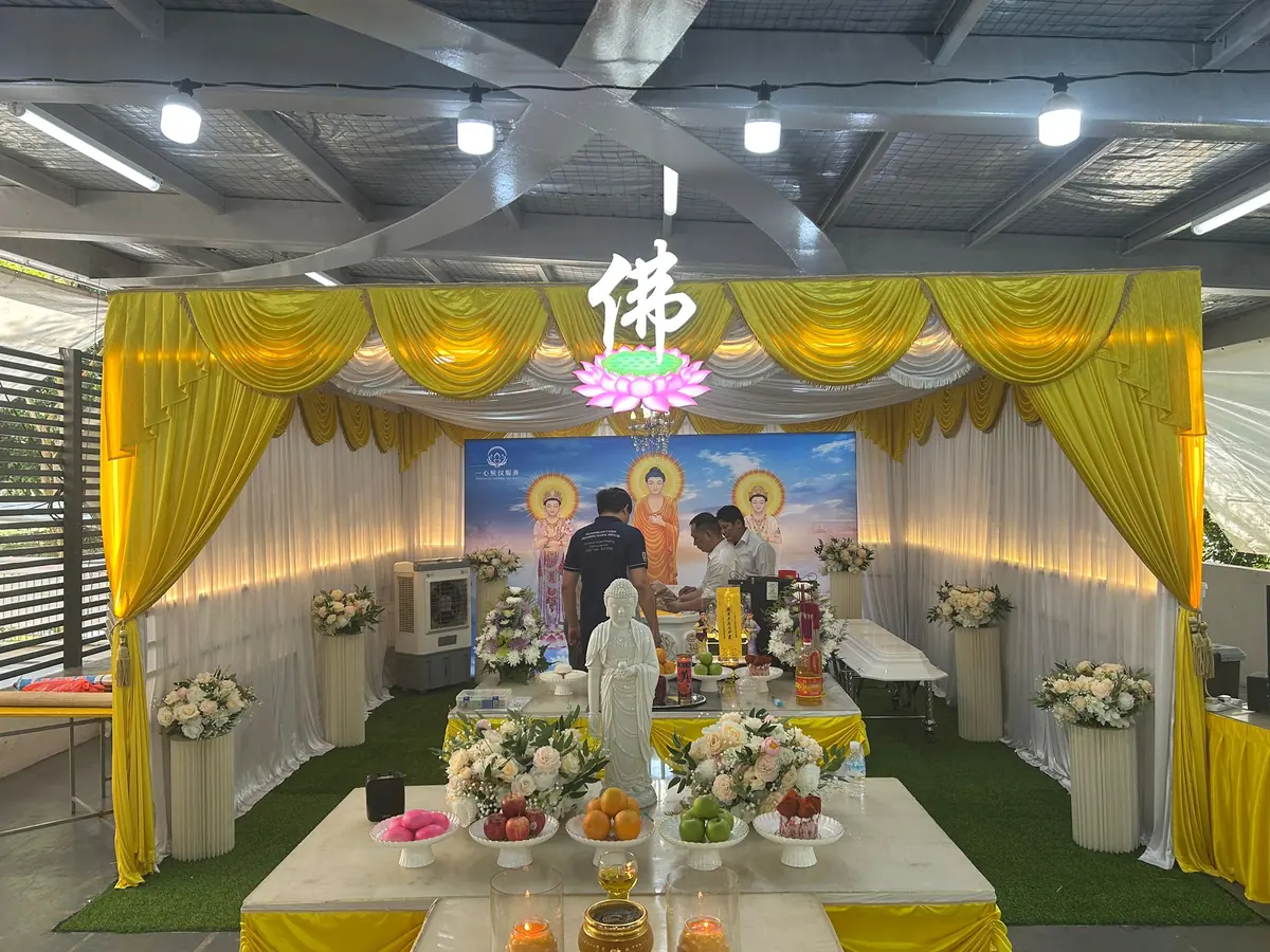 Wide view of a Buddhist funeral altar and wake setup