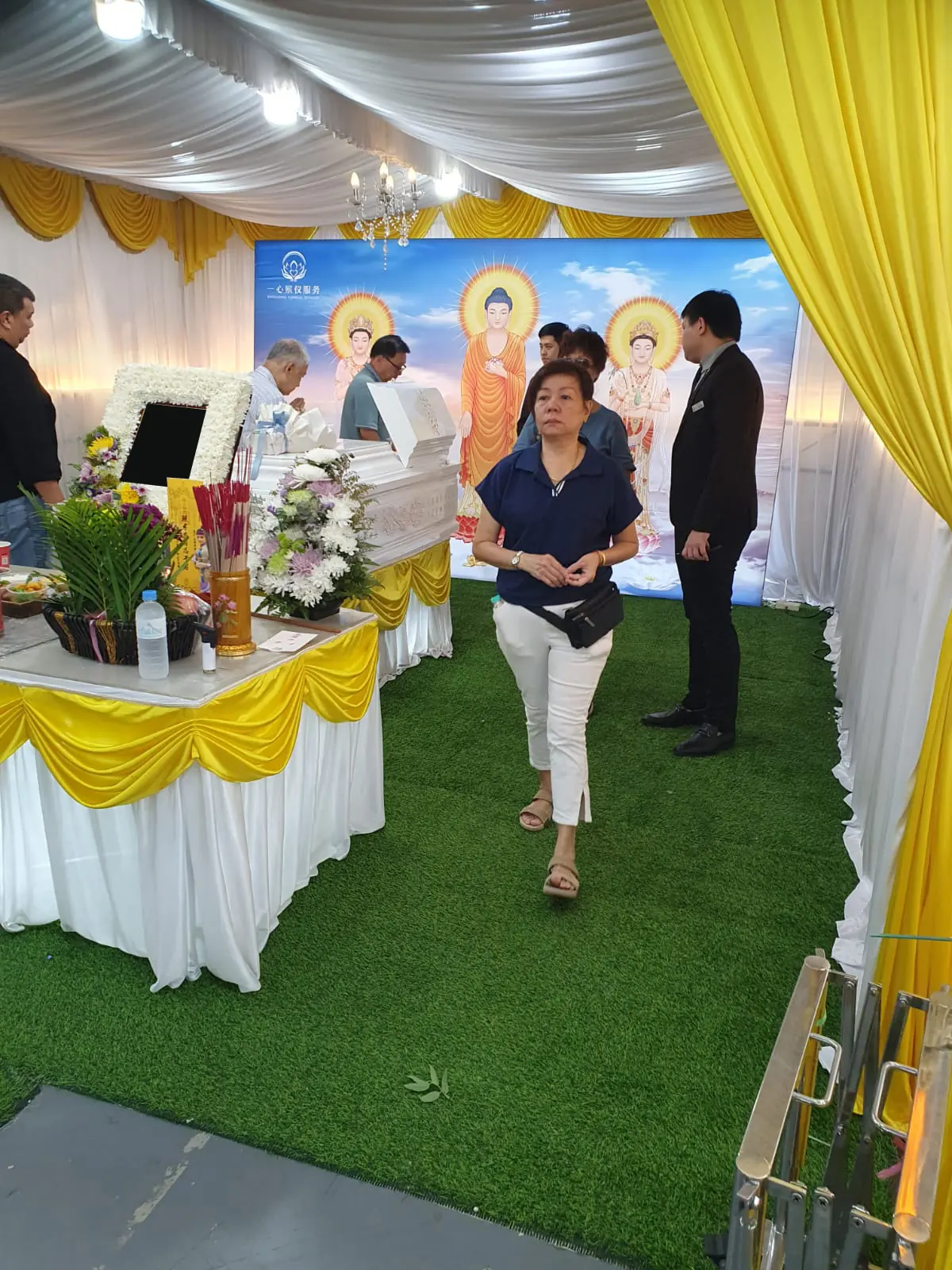 Family arriving at a Buddhist funeral wake