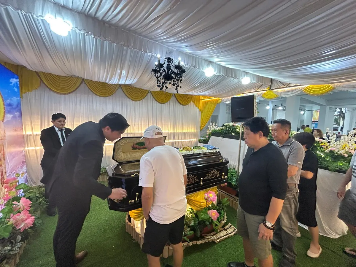 Family gathered around the casket for a final farewell