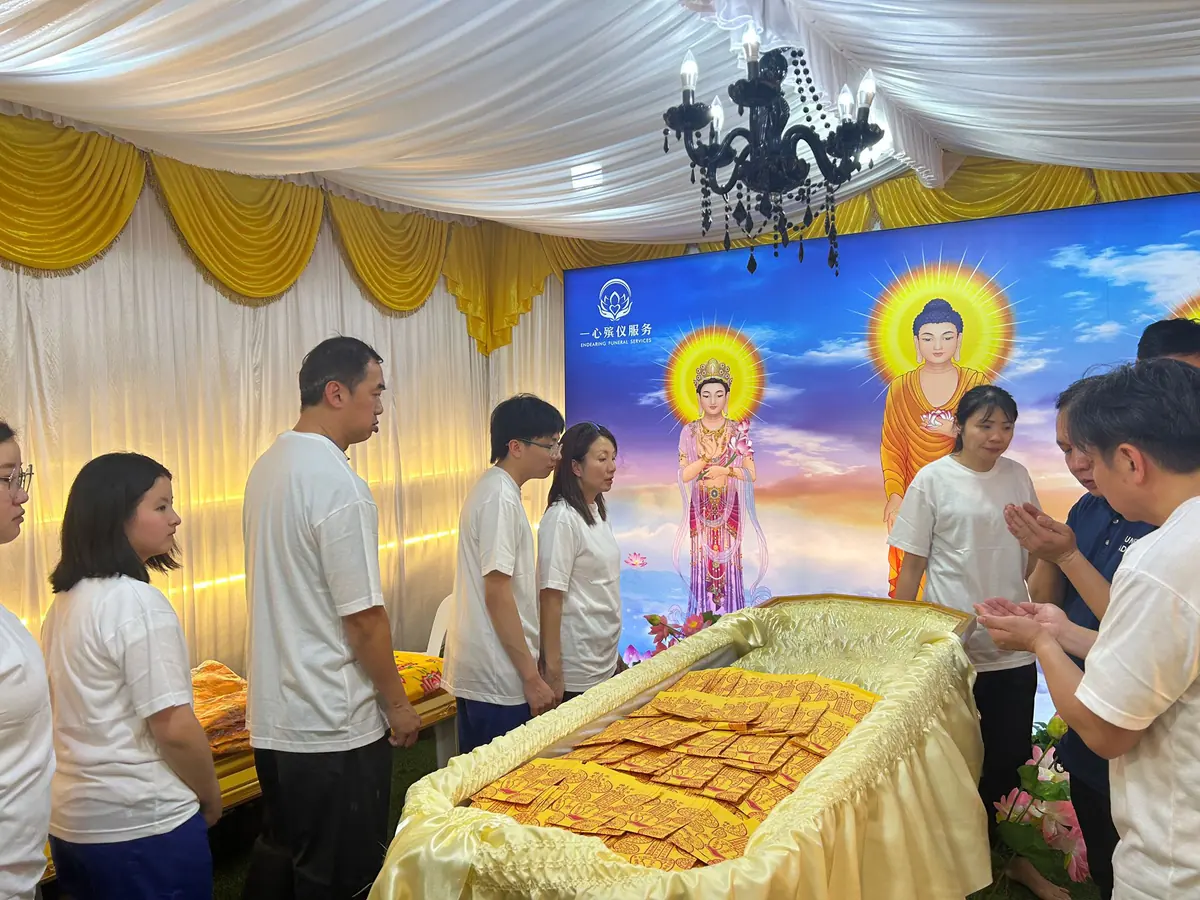 Family preparing Buddhist religious items for the deceased