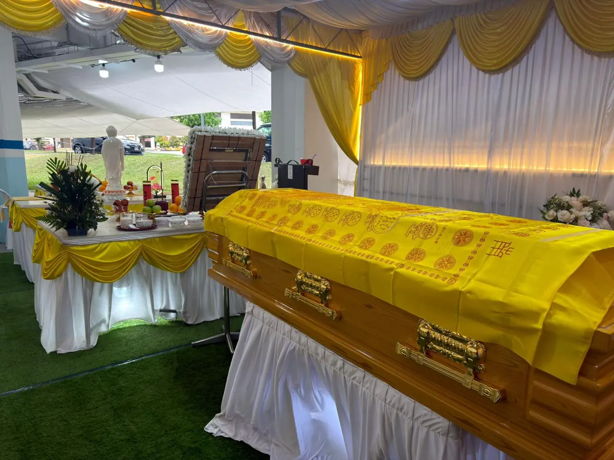 Buddhist funeral casket covered with a prayer blanket